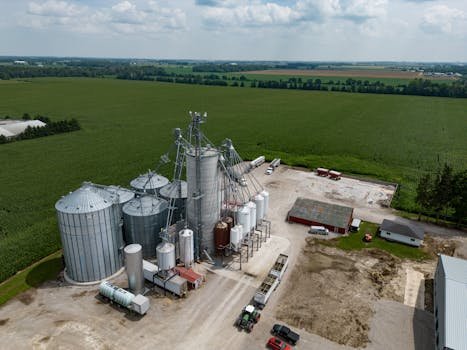 Drone shot capturing grain silos and vast fields in Dublin, Ontario, Canada.